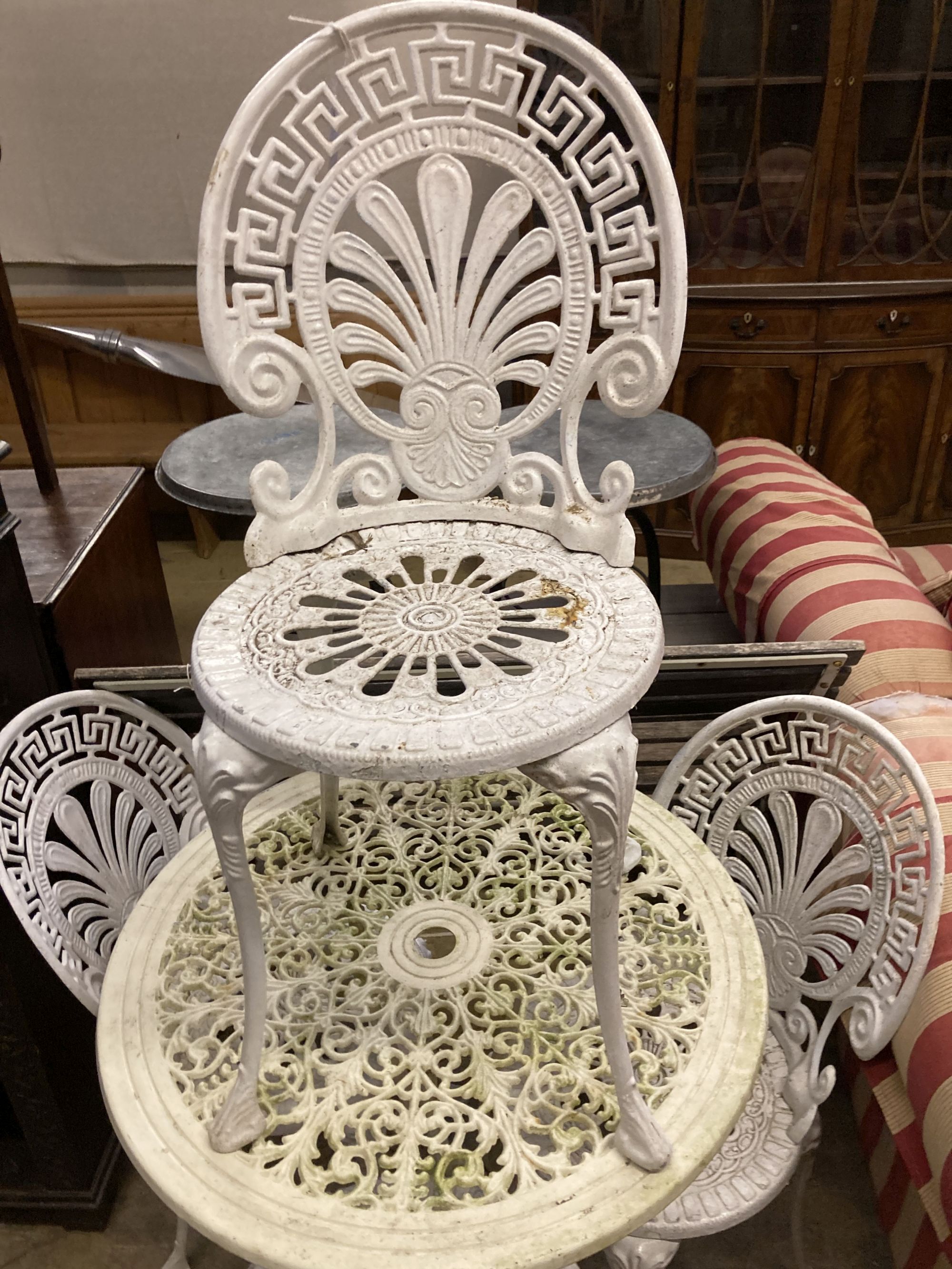 A circular Victorian style painted aluminium garden table, diameter 69cm together with a set of four similar chairs